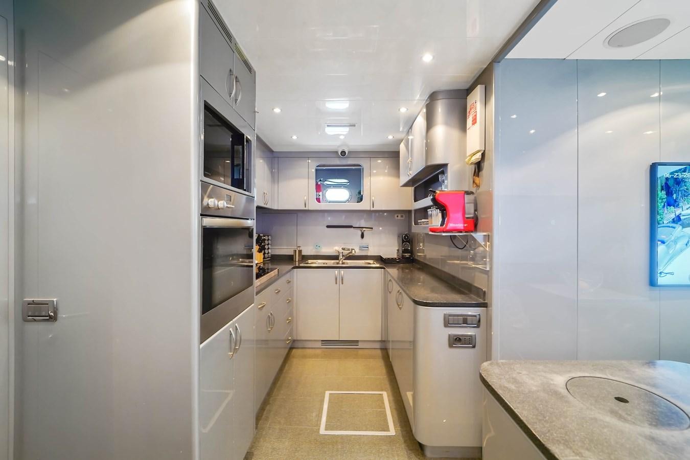 a kitchen with a microwave oven and a sink aboard 108' MANGUSTA 2002 Yacht for Sale