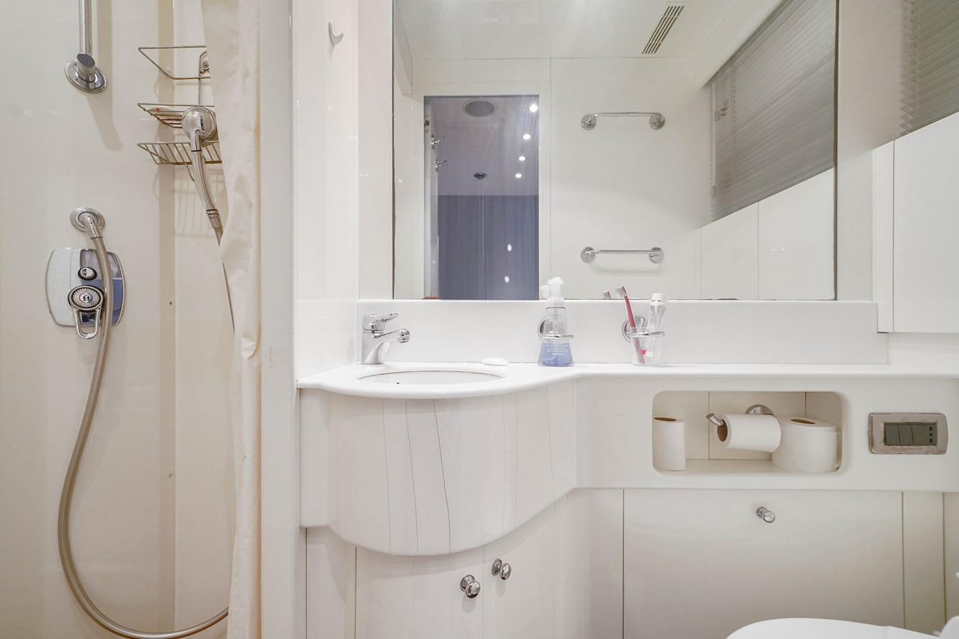 a bathroom with a shower curtain aboard 108' MANGUSTA 2002 Yacht for Sale