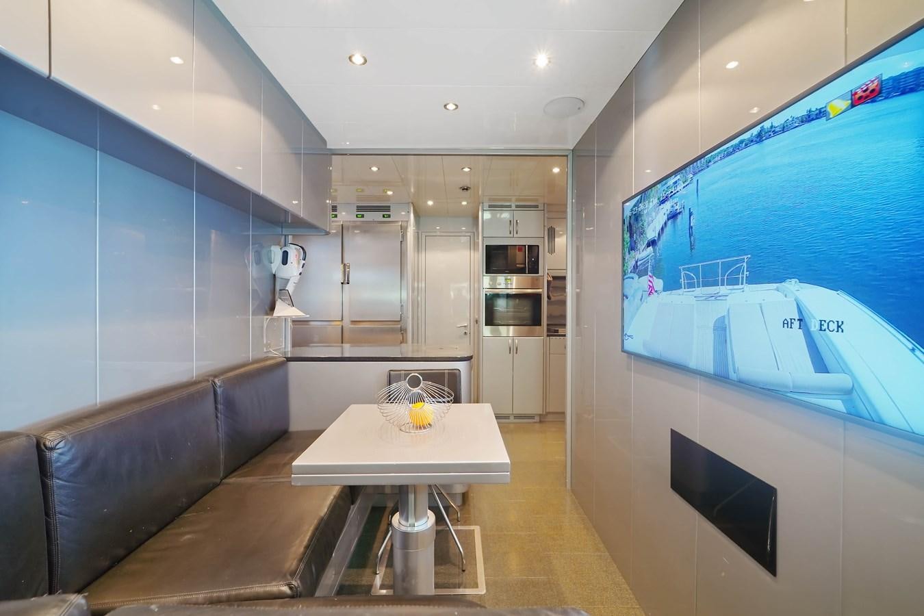 a kitchen and living room aboard 108' MANGUSTA 2002 Yacht for Sale
