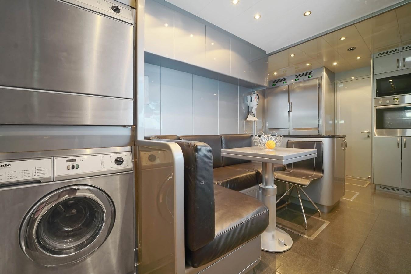 a kitchen with a table and a large oven aboard 108' MANGUSTA 2002 Yacht for Sale