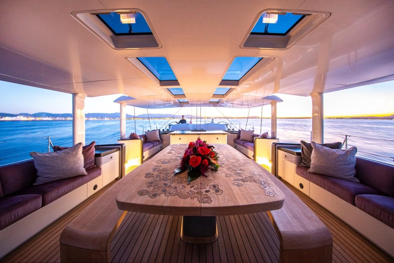 a room with a table and chairs aboard PINK GIN Yacht for Sale