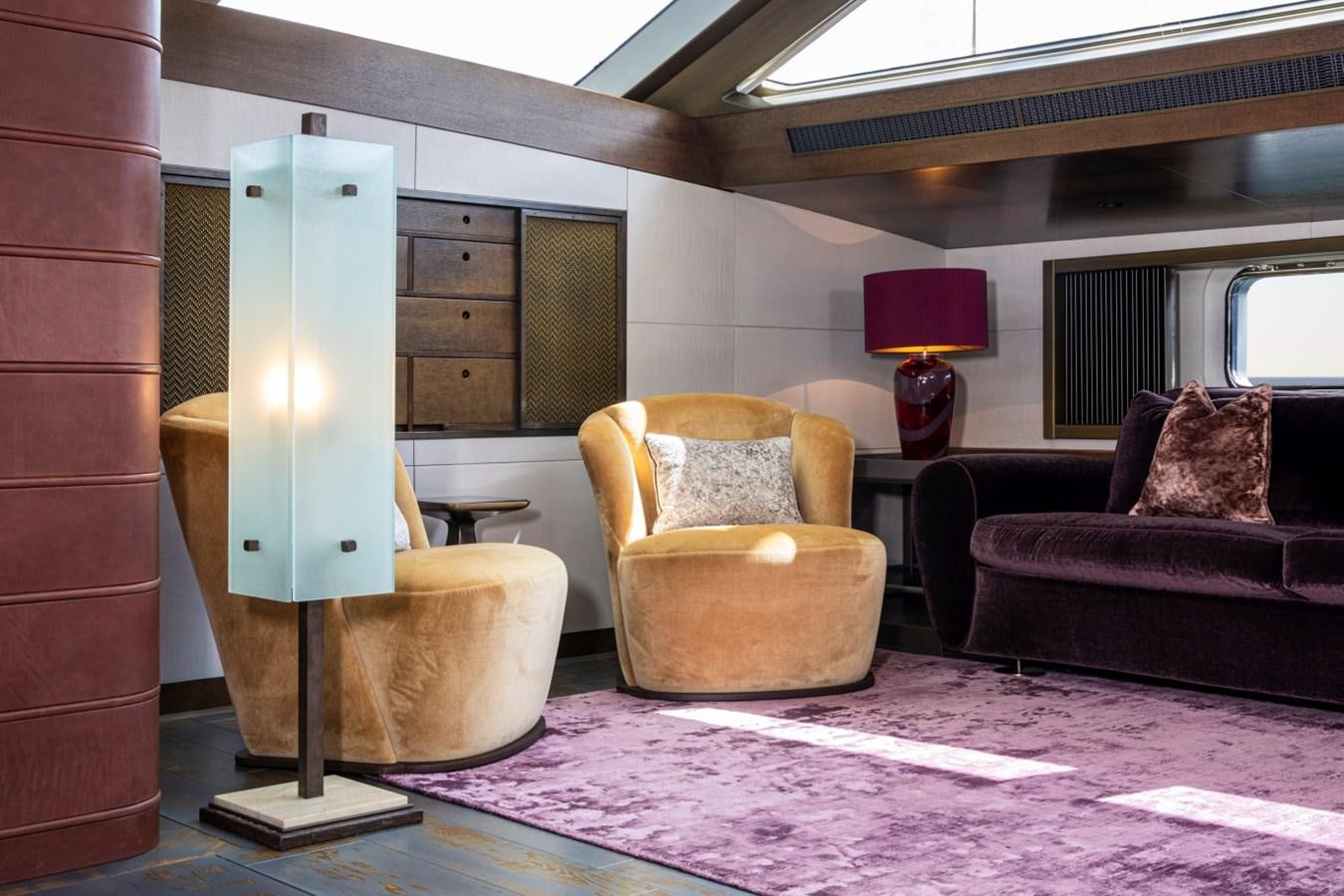 a living room with a lamp and couches aboard PINK GIN Yacht for Sale