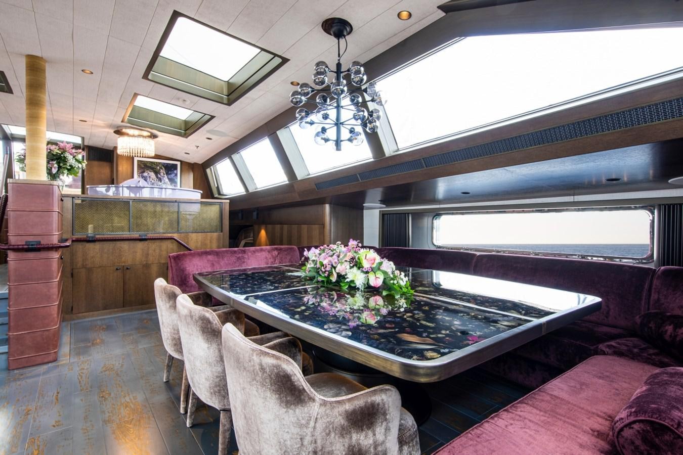 a room with a table and chairs aboard PINK GIN Yacht for Sale