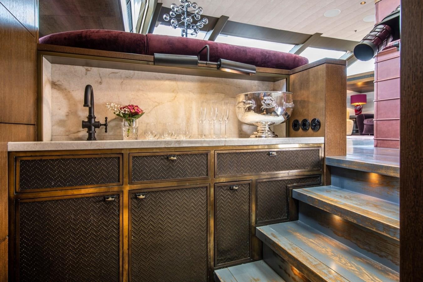 a kitchen with a large wooden cabinet aboard PINK GIN Yacht for Sale