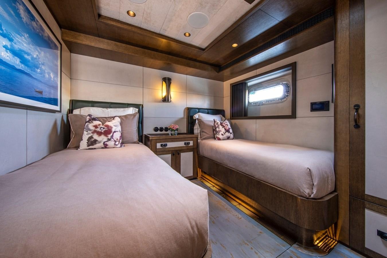 a bedroom with a bed and a television aboard PINK GIN Yacht for Sale