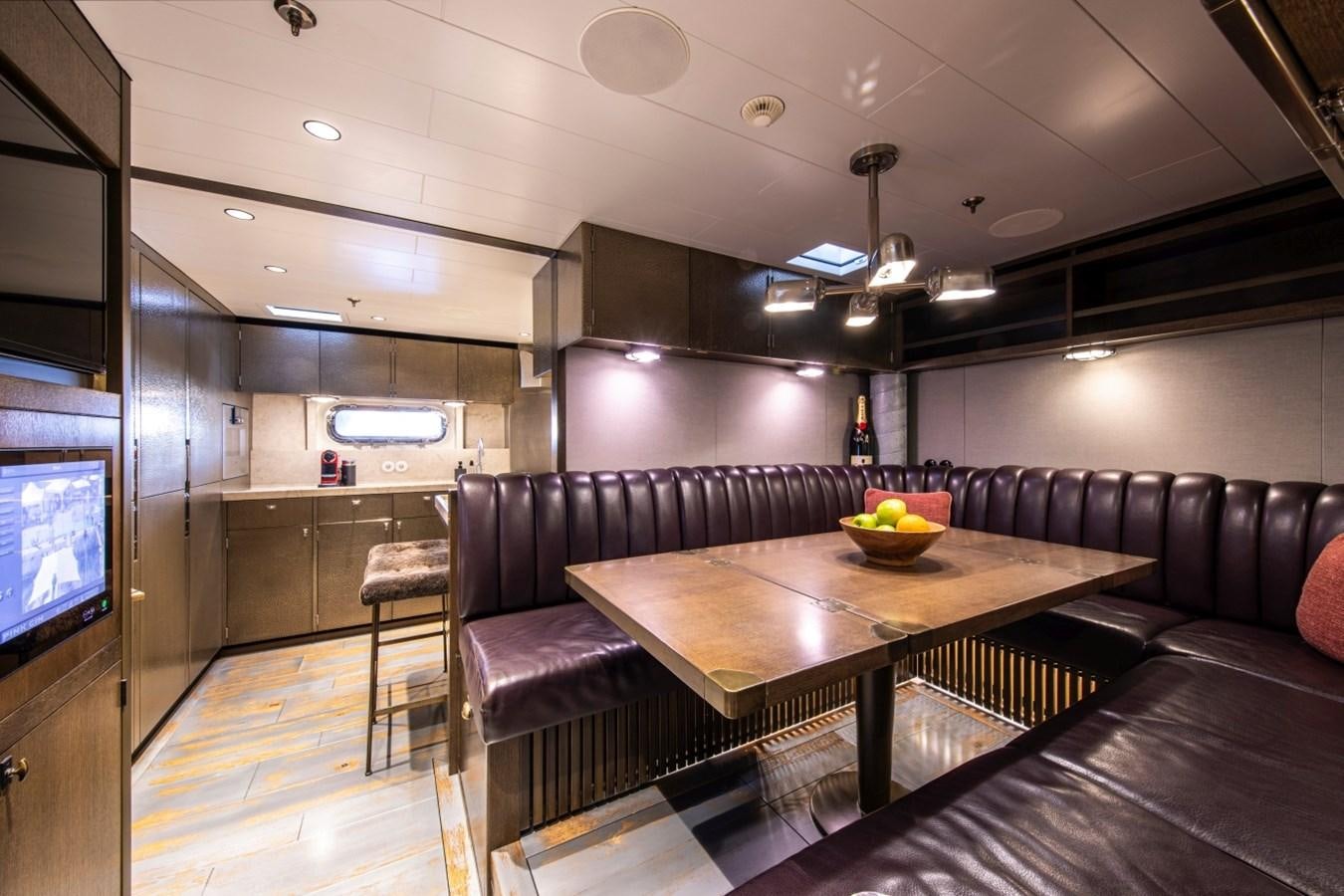 a room with a table and couches aboard PINK GIN Yacht for Sale
