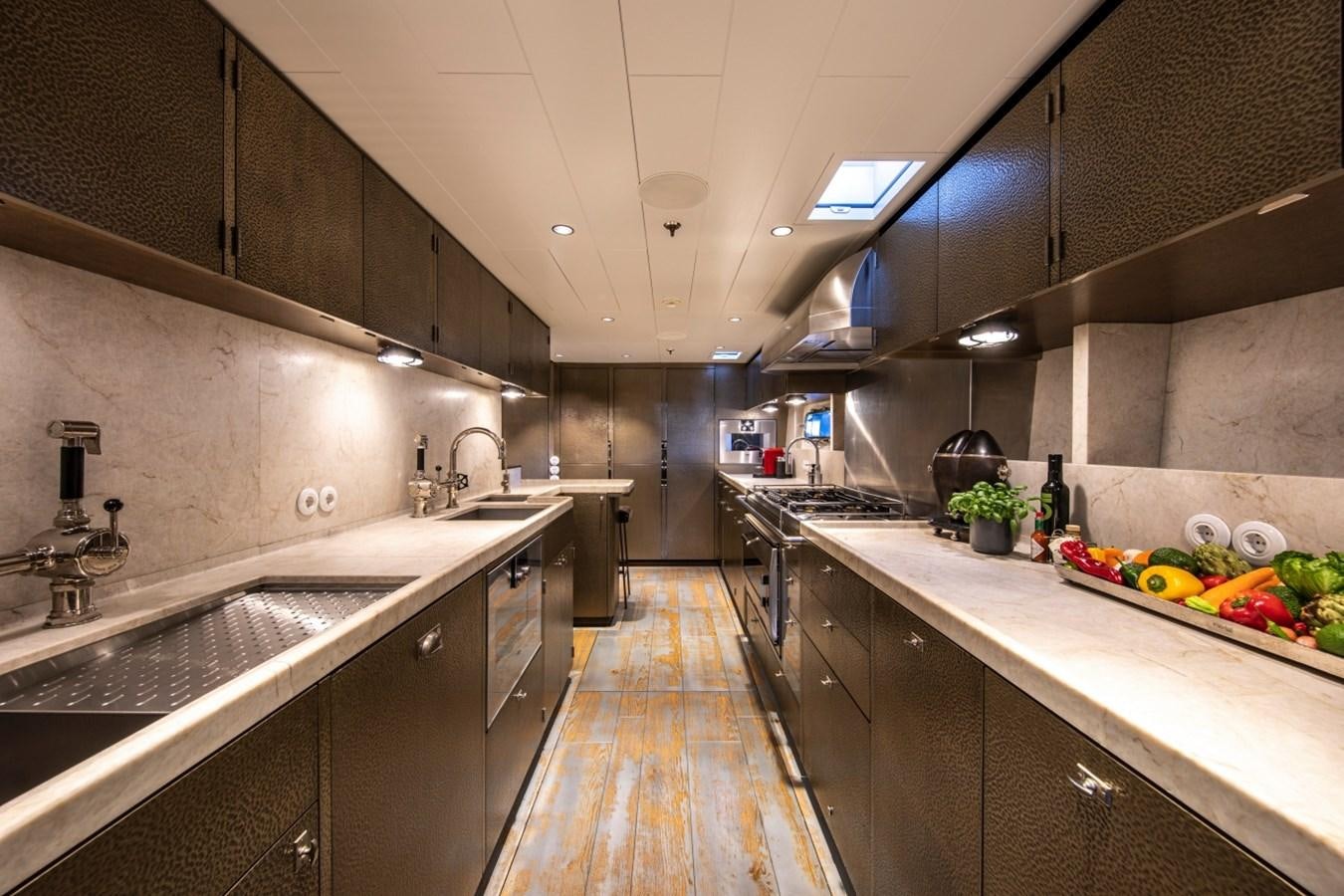a kitchen with a large island aboard PINK GIN Yacht for Sale