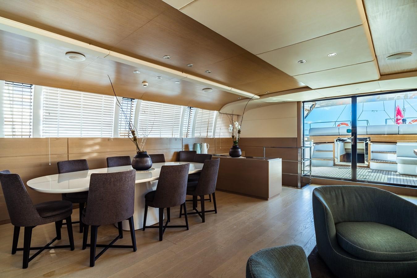a large room with a table and chairs aboard ONE FORCE Yacht for Sale