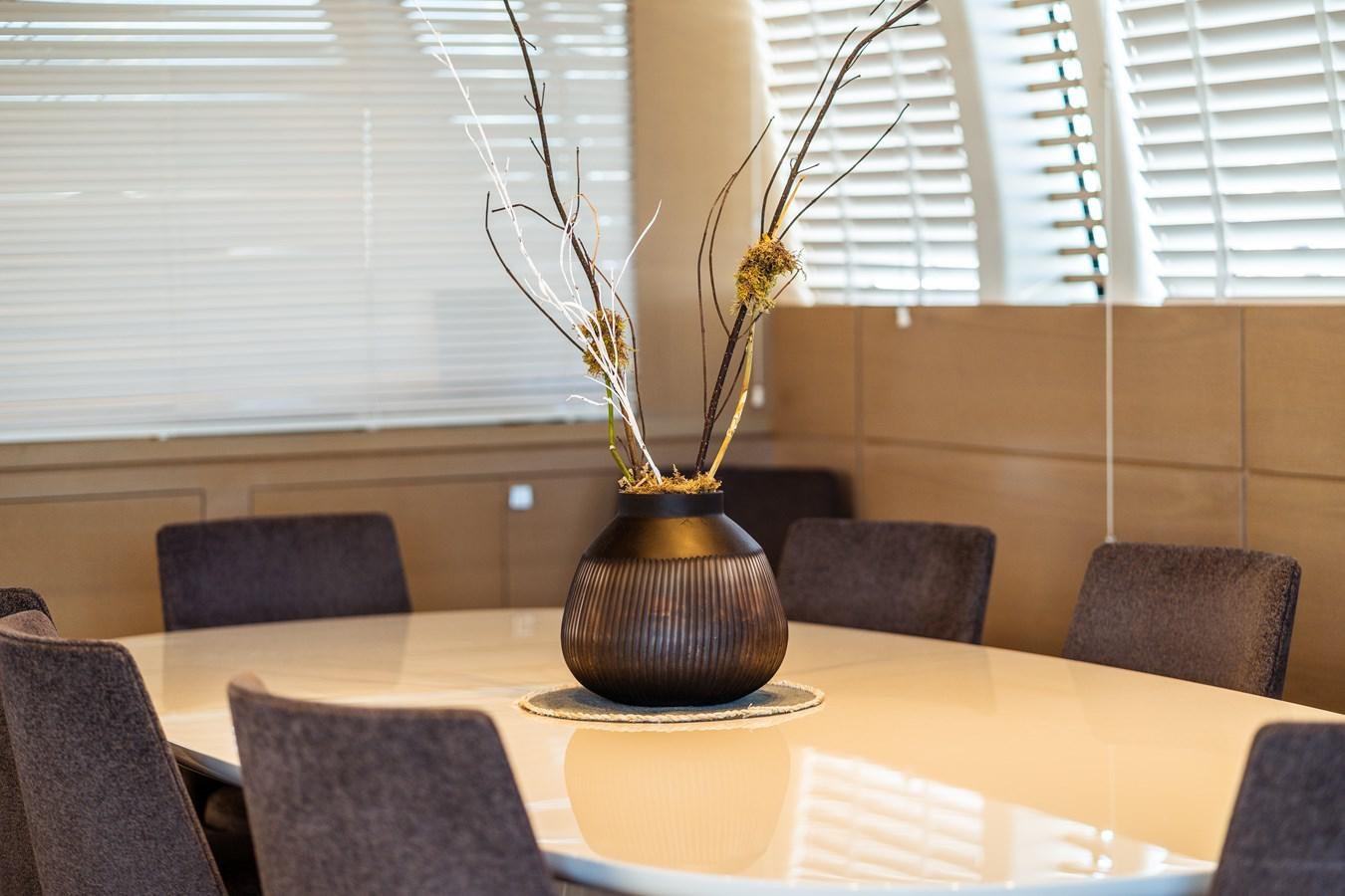 a vase with flowers on a table aboard ONE FORCE Yacht for Sale