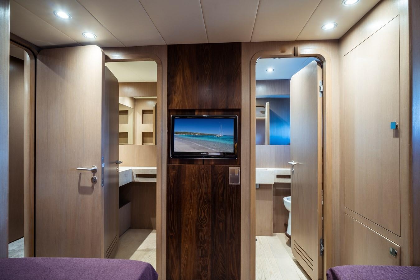 a room with a tv and a closet aboard ONE FORCE Yacht for Sale