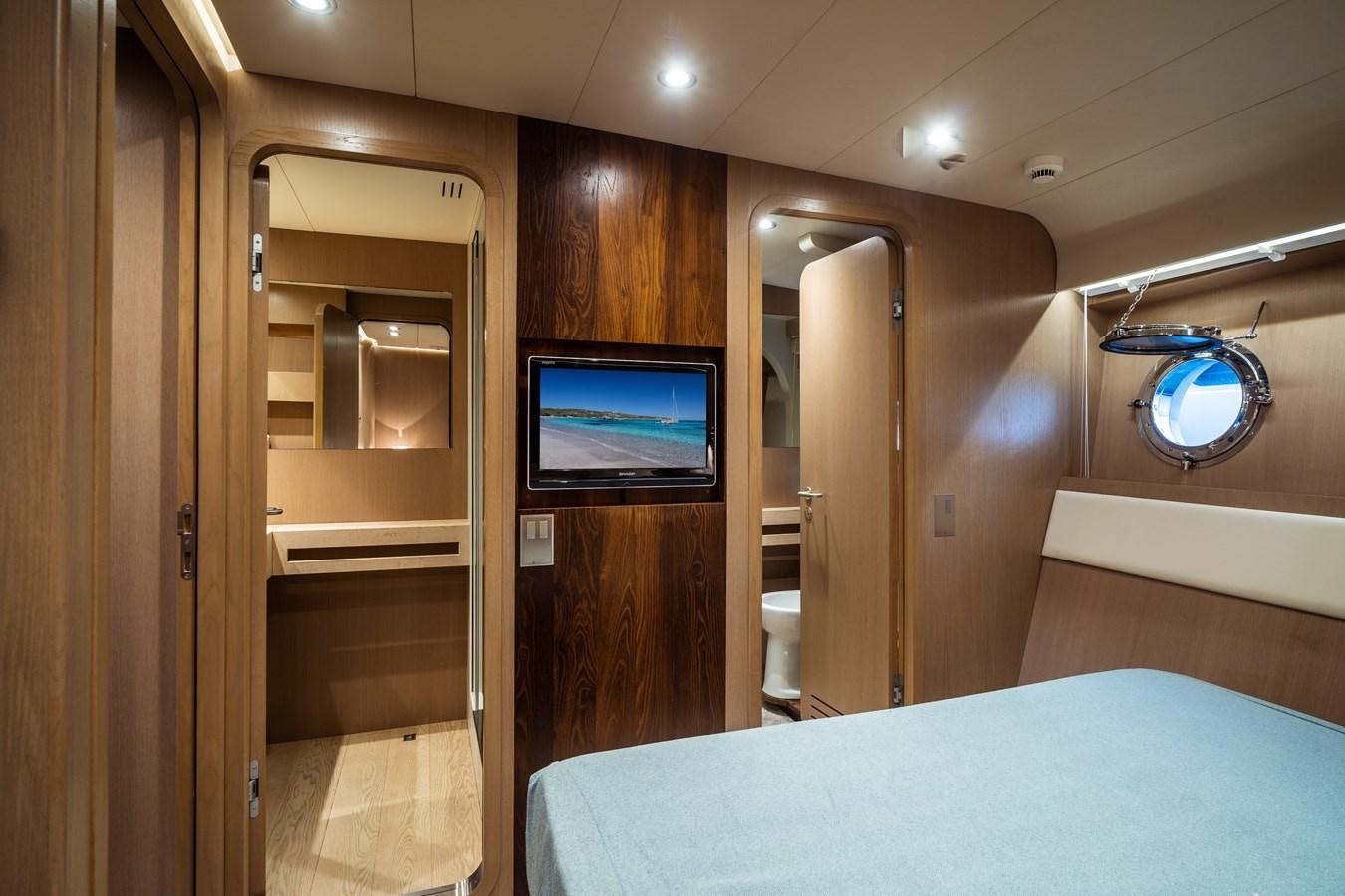 a room with a bed and a television aboard ONE FORCE Yacht for Sale