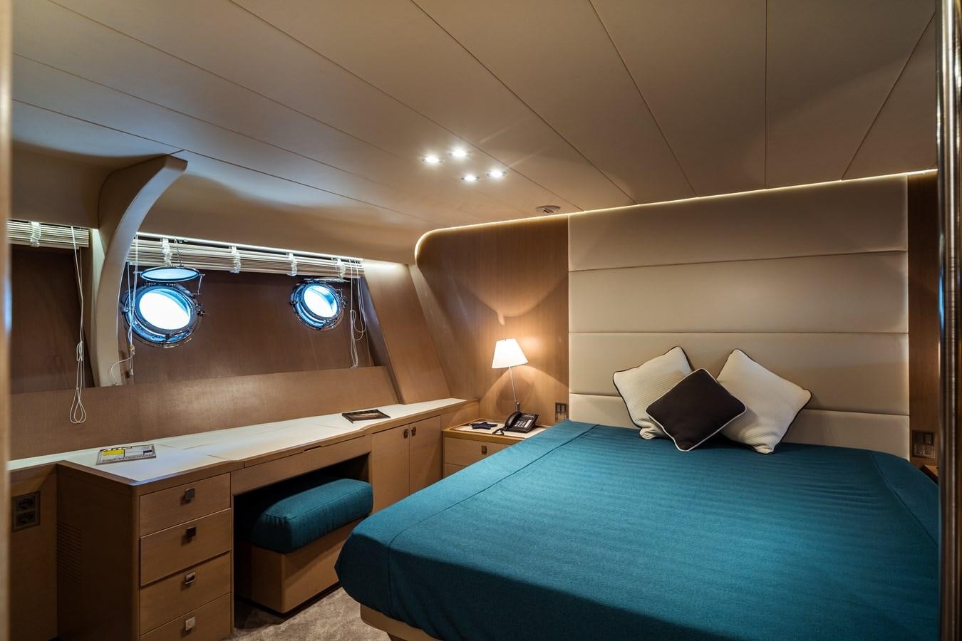 a room with a bed and desk aboard ONE FORCE Yacht for Sale