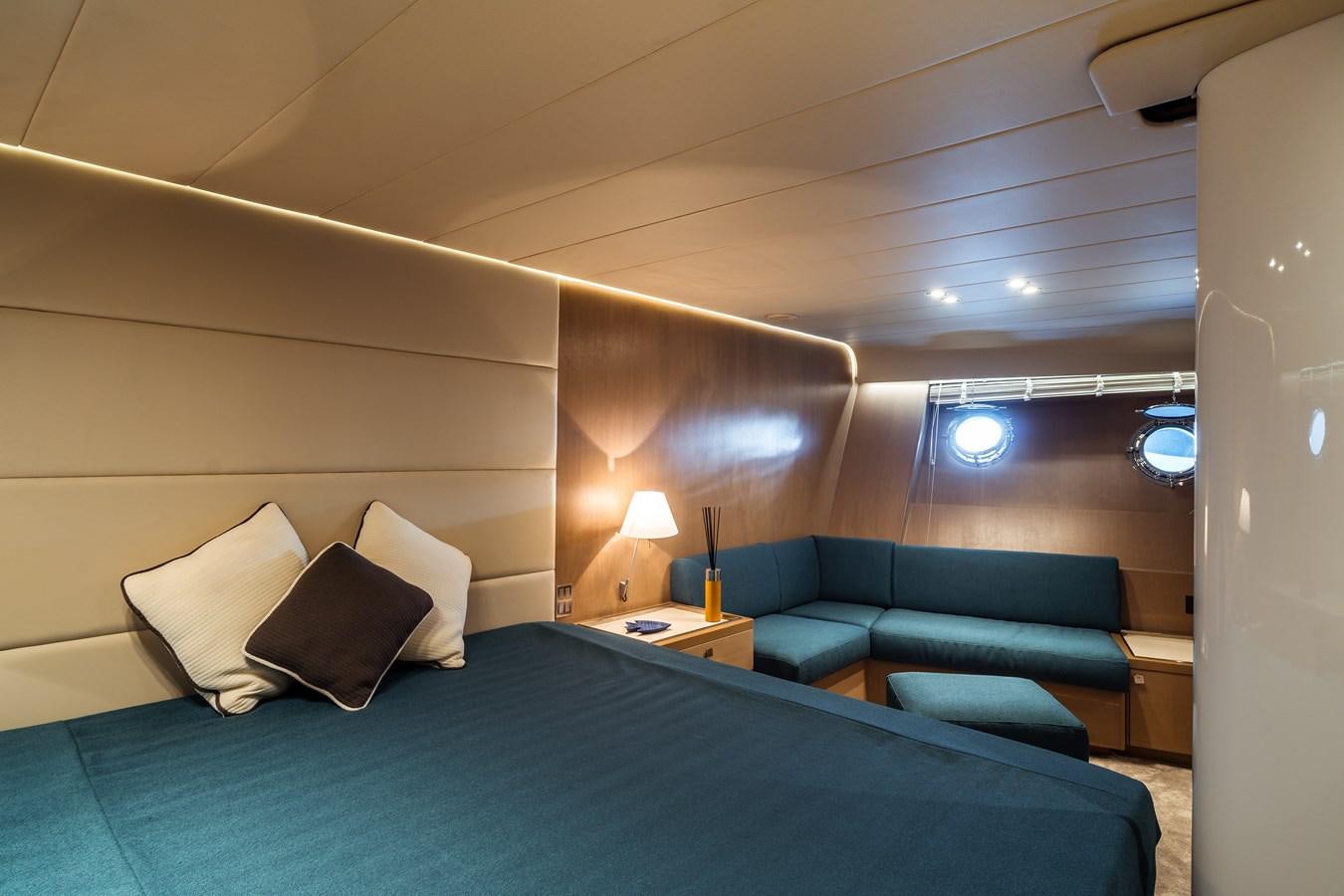 a bed with a blue bed spread aboard ONE FORCE Yacht for Sale