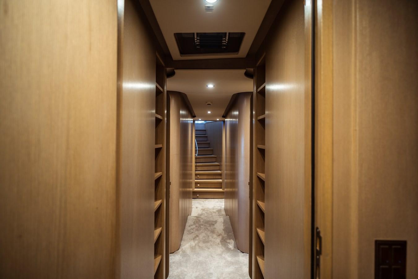a hallway with a door and a staircase aboard ONE FORCE Yacht for Sale