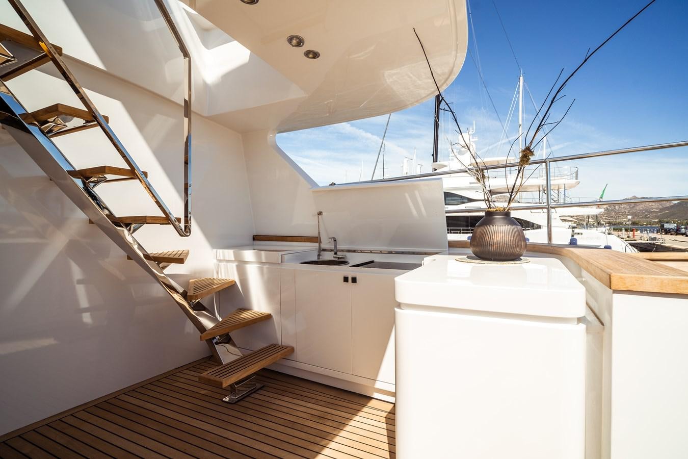 a white kitchen with a white refrigerator aboard ONE FORCE Yacht for Sale