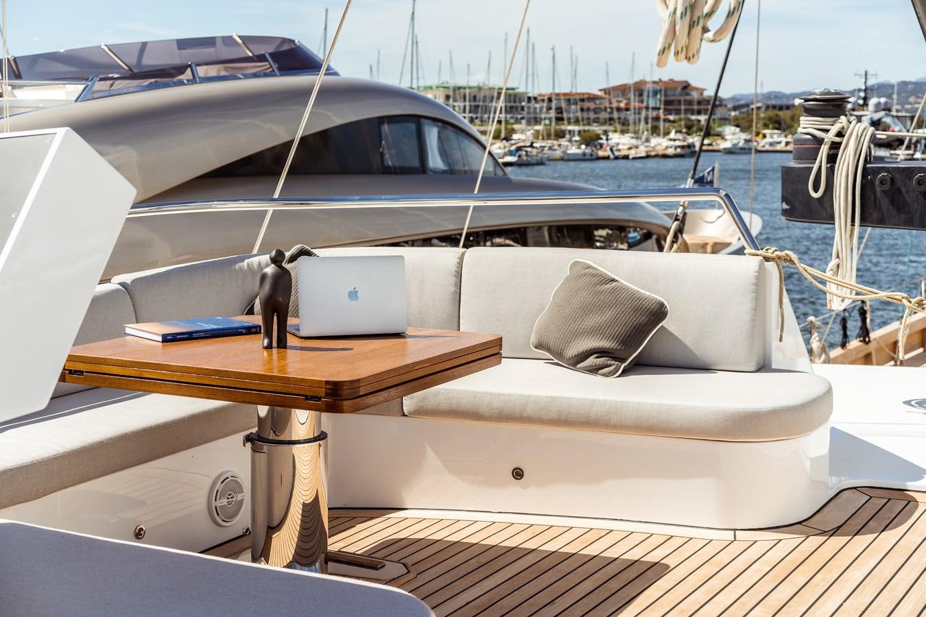 a boat with a seat and a table on it aboard ONE FORCE Yacht for Sale