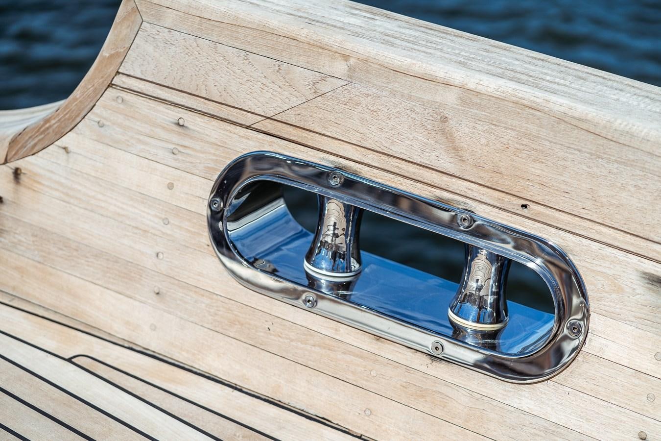 a pair of sunglasses on a wood surface aboard ONE FORCE Yacht for Sale