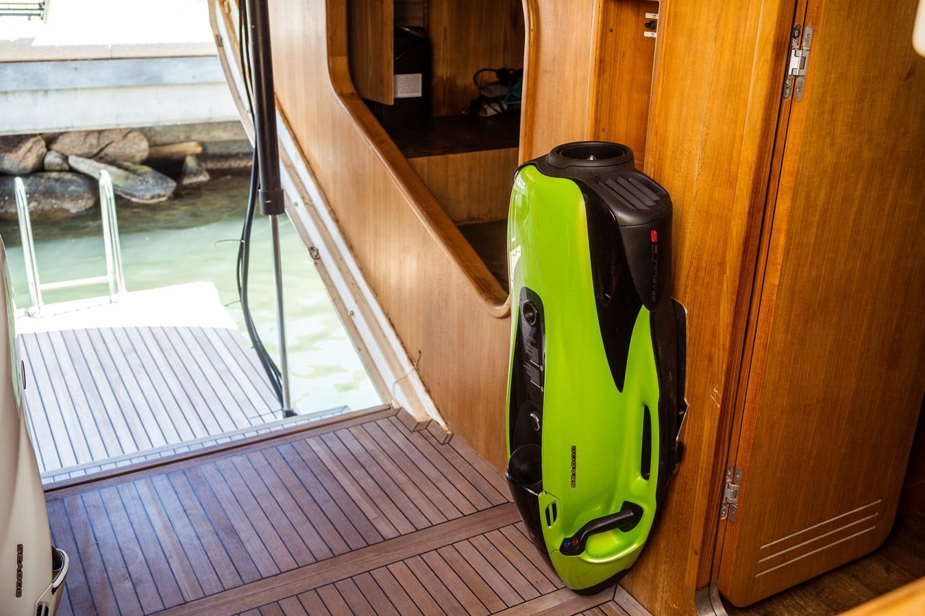 a black and green can on a wooden surface aboard ONE FORCE Yacht for Sale