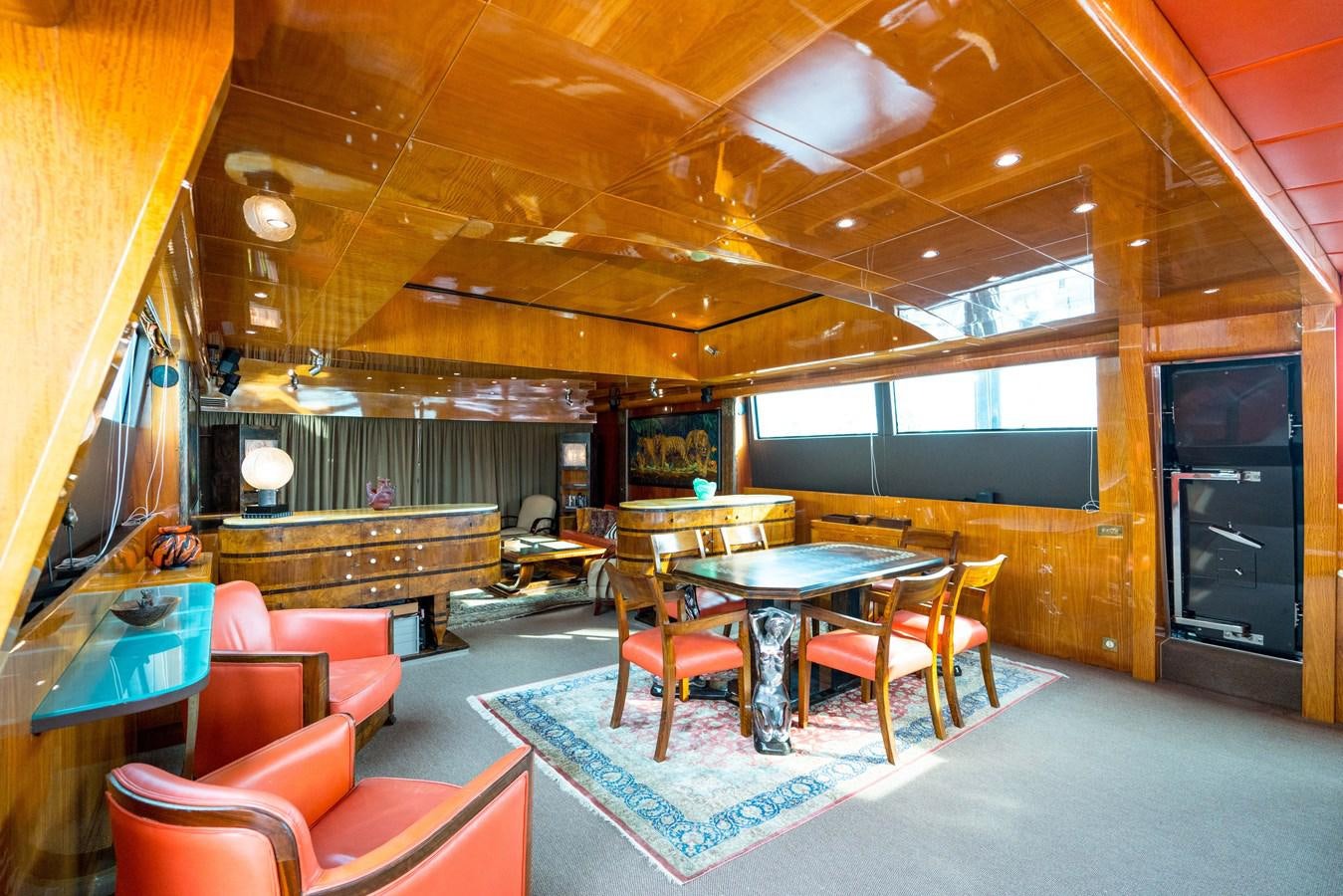 a room with a table chairs and a large window aboard CHASING SPIRIT Yacht for Sale