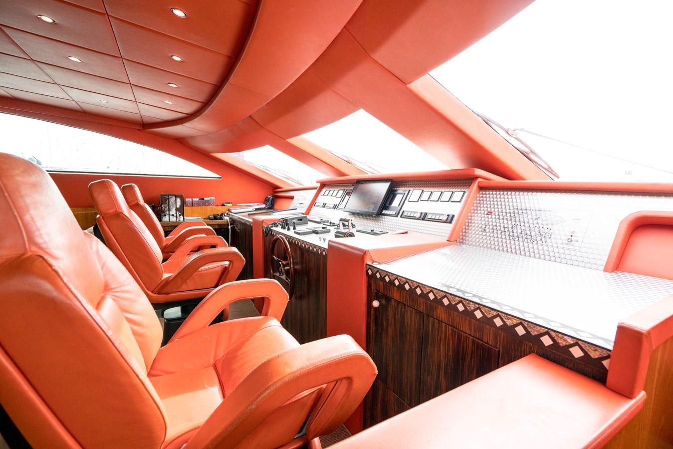 a room with a piano and a red seat aboard CHASING SPIRIT Yacht for Sale