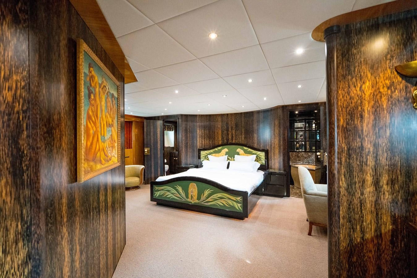 a room with a bed and a chair aboard CHASING SPIRIT Yacht for Sale