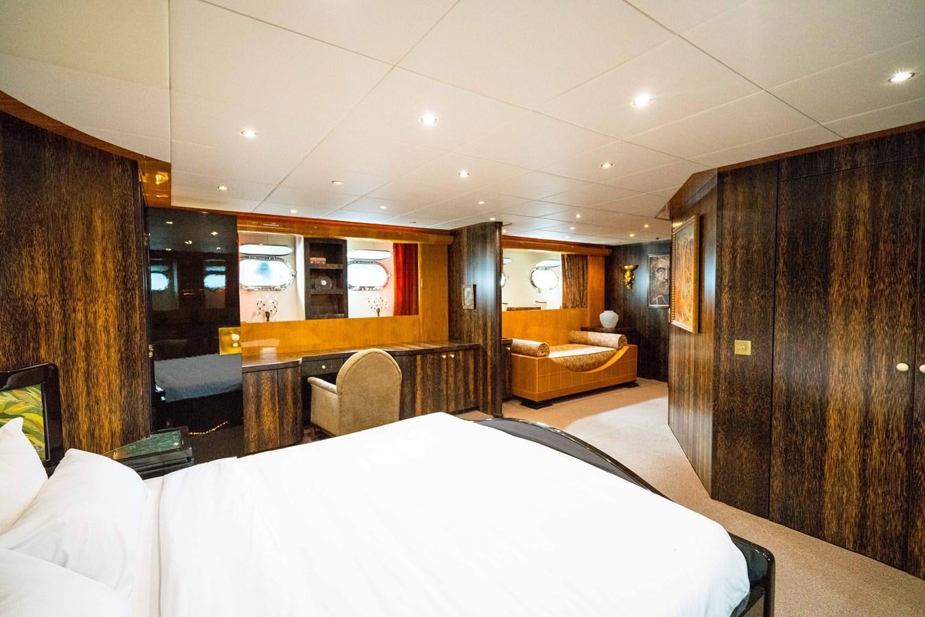 a room with a bed and a desk aboard CHASING SPIRIT Yacht for Sale