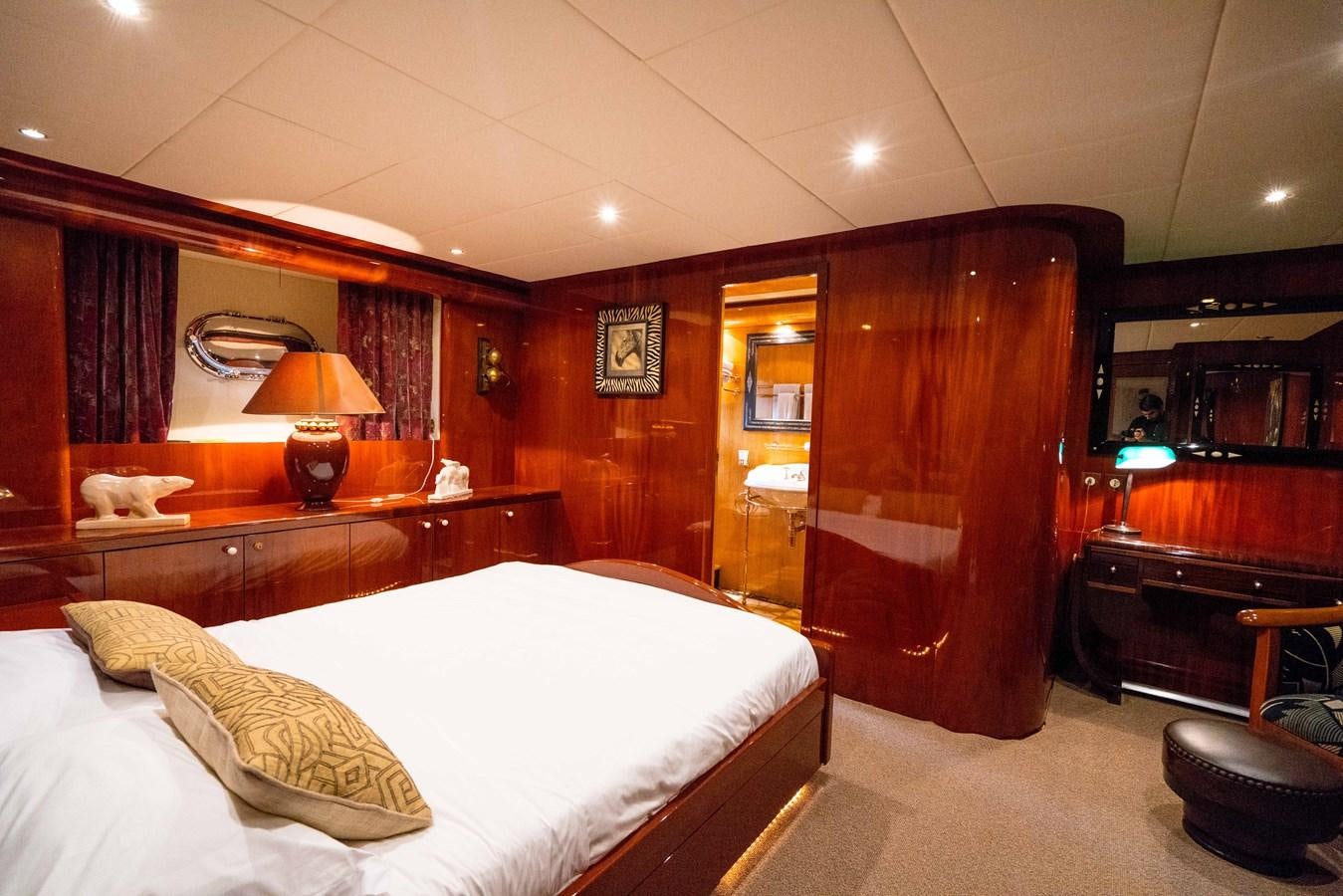 a bedroom with a bed and a desk aboard CHASING SPIRIT Yacht for Sale