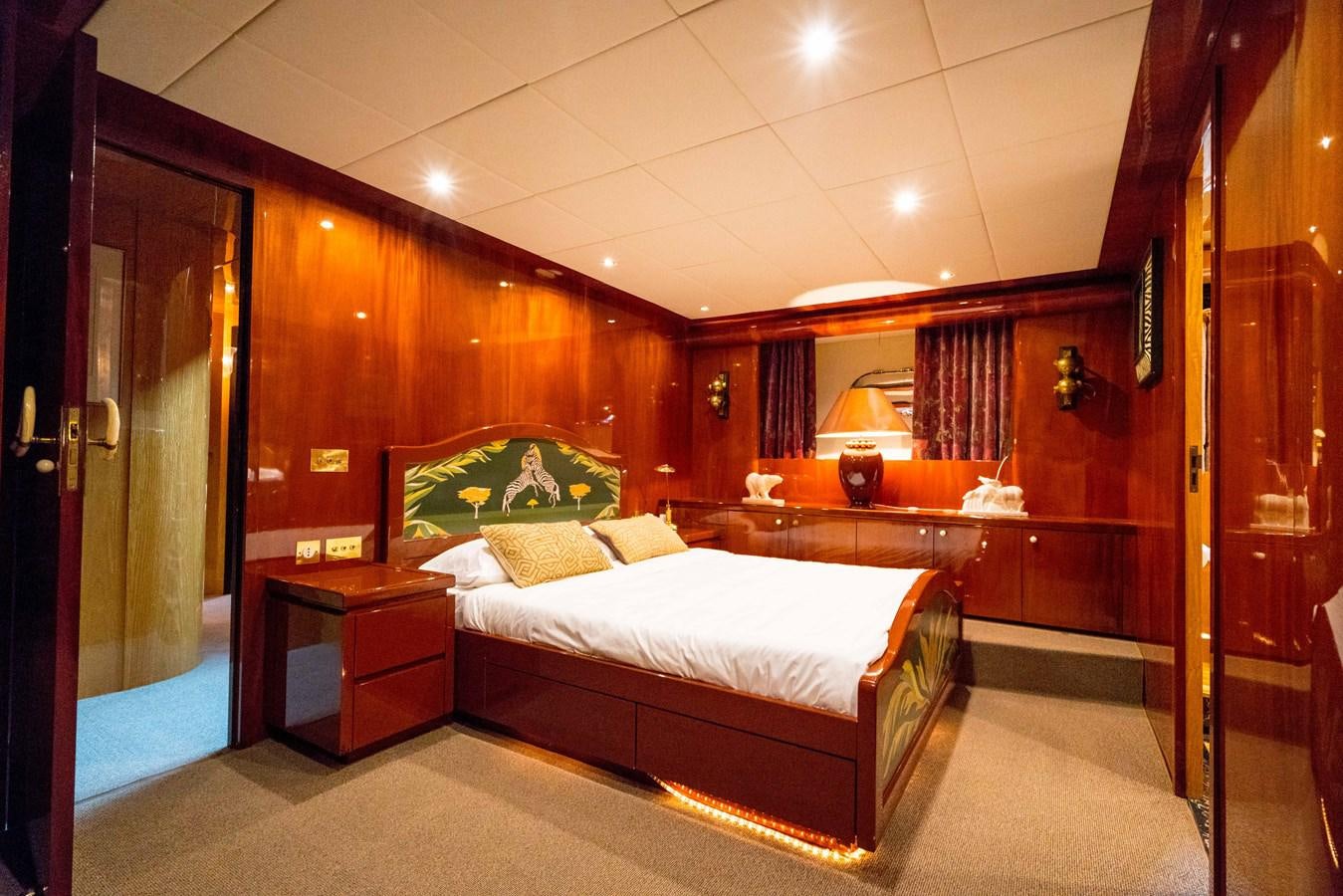 a bedroom with a bed and a desk aboard CHASING SPIRIT Yacht for Sale