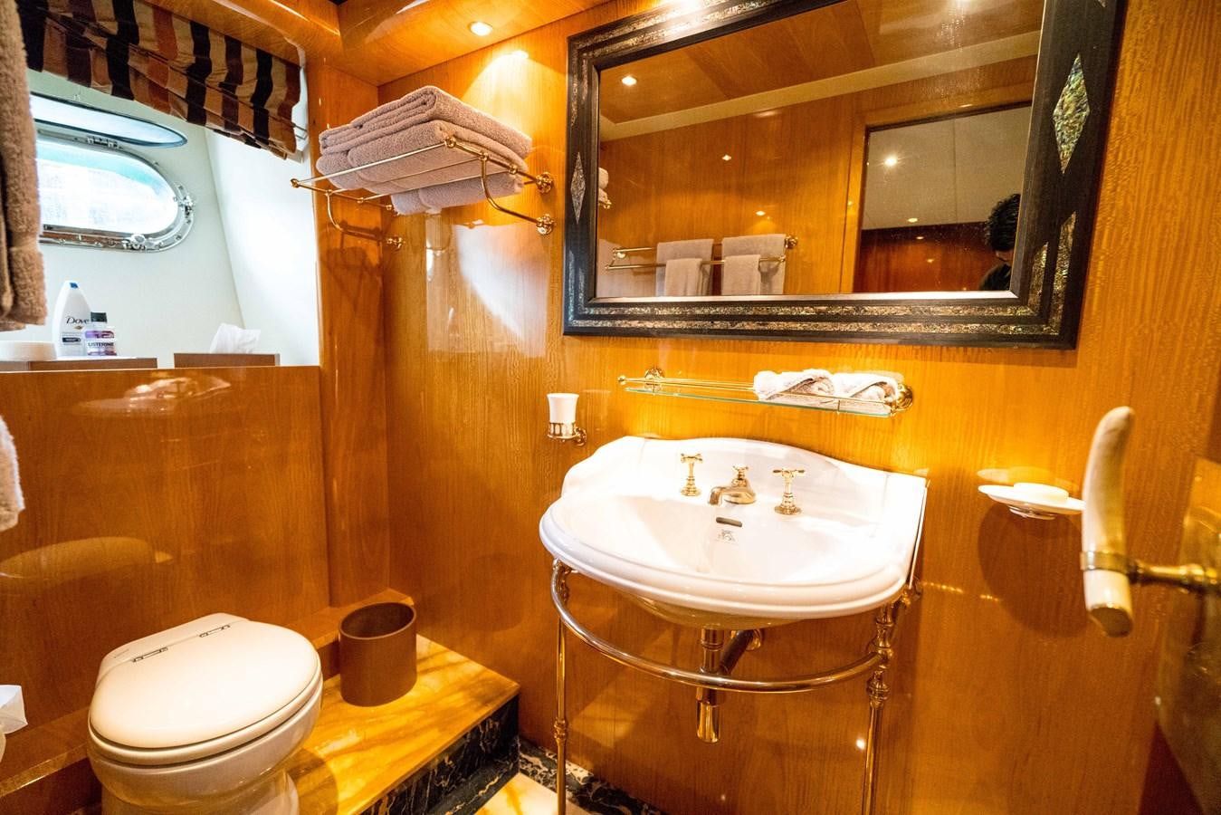 a bathroom with a sink toilet and a mirror aboard CHASING SPIRIT Yacht for Sale