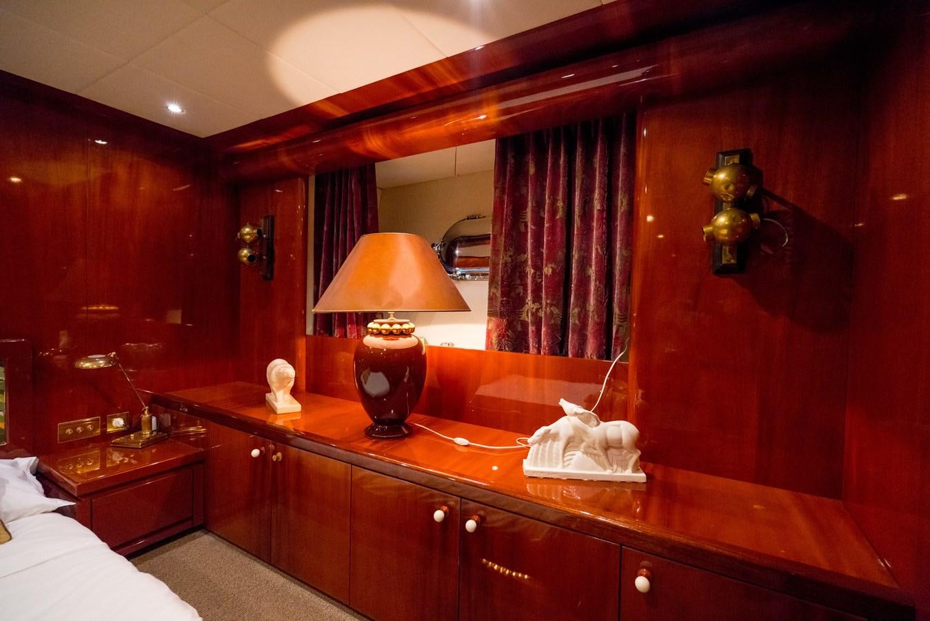 a room with a lamp and a mirror aboard CHASING SPIRIT Yacht for Sale