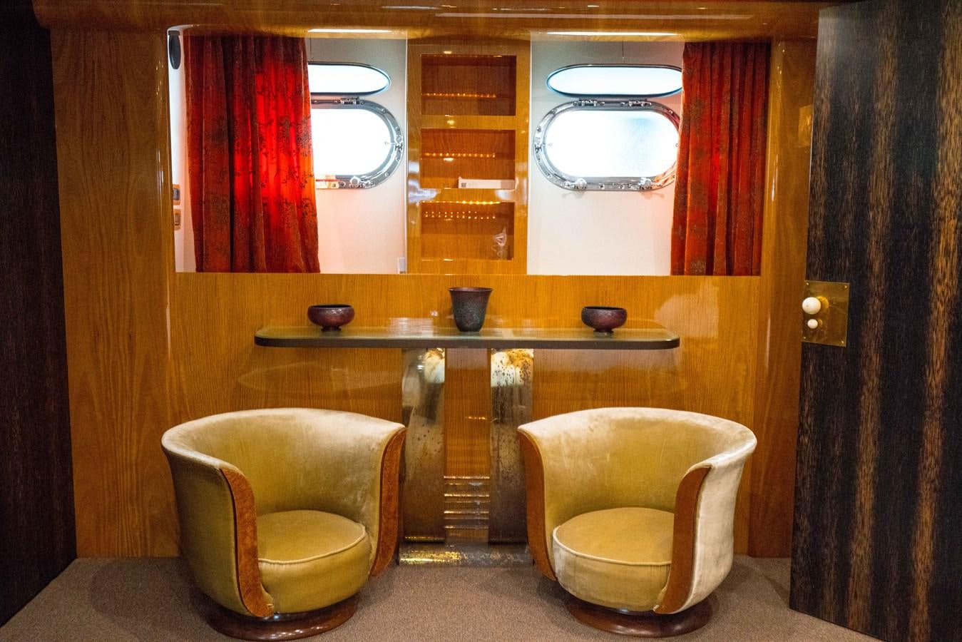 a bathroom with a toilet and a chair aboard CHASING SPIRIT Yacht for Sale
