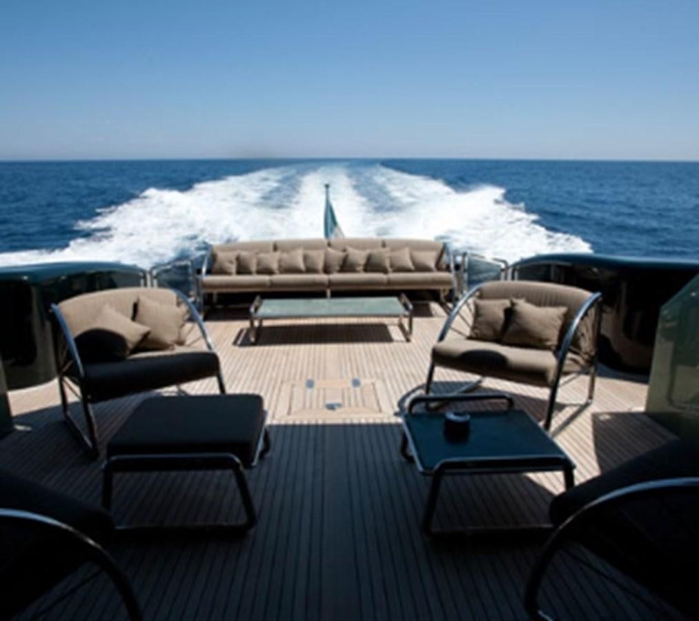 a deck with chairs and a body of water in the background aboard CHASING SPIRIT Yacht for Sale