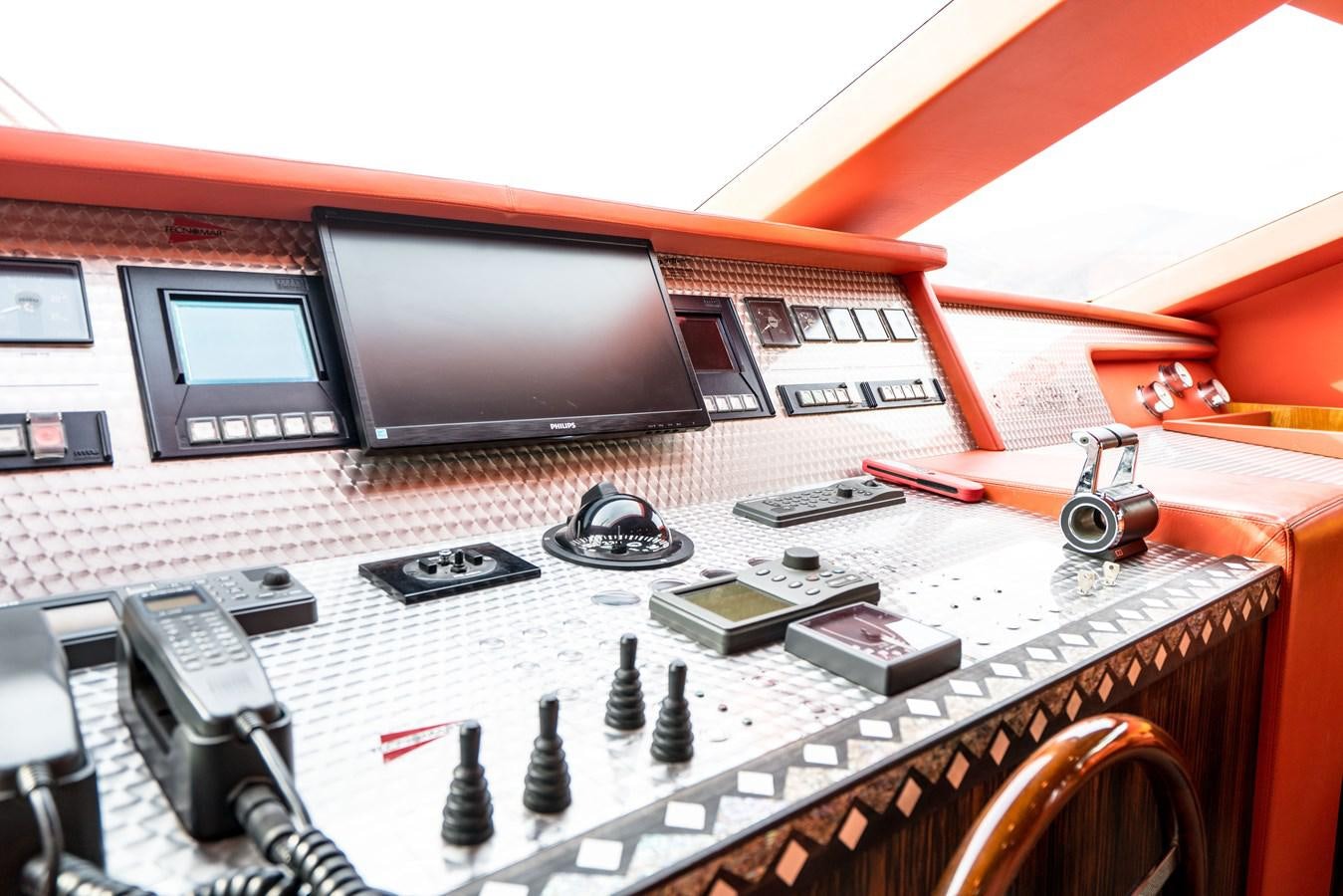 a table with a computer and other electronics on it aboard CHASING SPIRIT Yacht for Sale