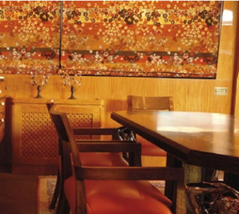 a room with a table and chairs aboard CHASING SPIRIT Yacht for Sale