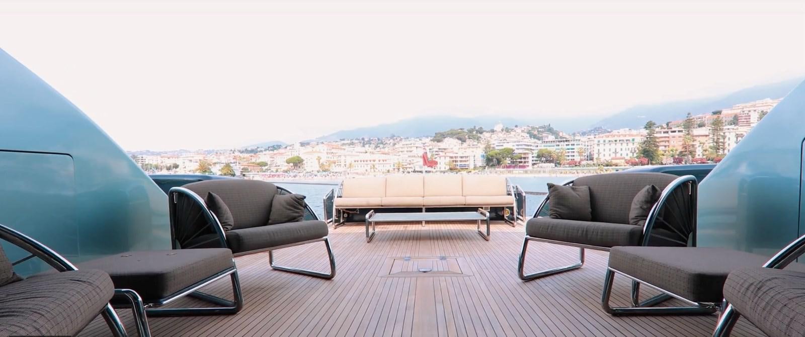 a room with a couch and a table and a view of a city aboard CHASING SPIRIT Yacht for Sale