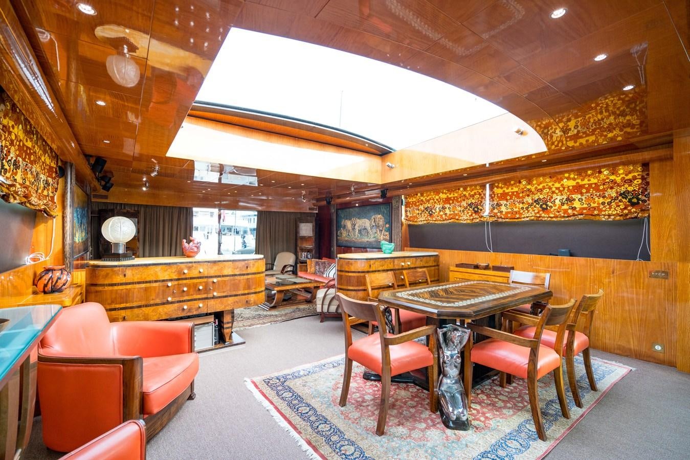 a room with a table chairs and a large window aboard CHASING SPIRIT Yacht for Sale
