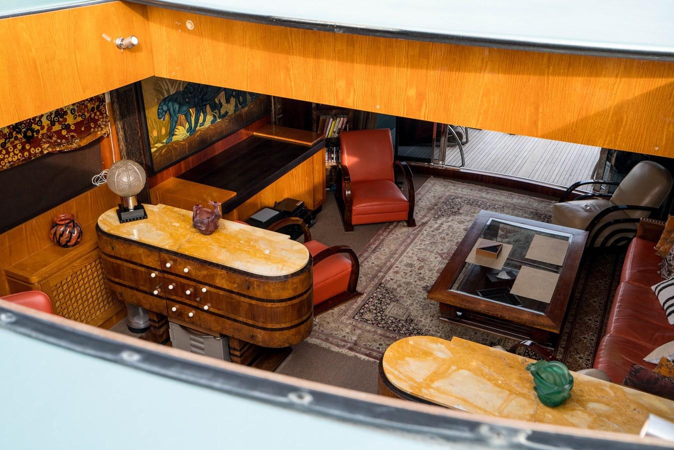 a room with a piano and chairs aboard CHASING SPIRIT Yacht for Sale
