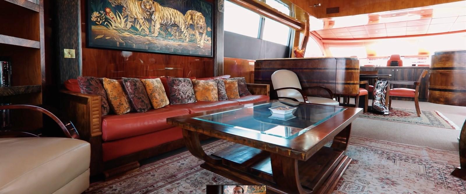 a living room with a leather couch and a table aboard CHASING SPIRIT Yacht for Sale