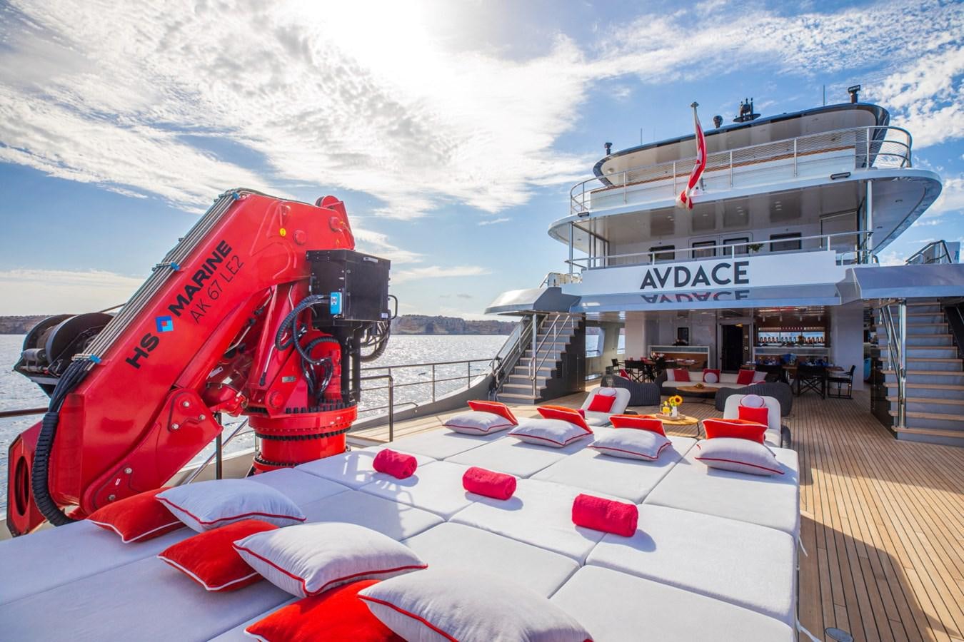 a boat with a red car on it aboard AUDACE Yacht for Sale