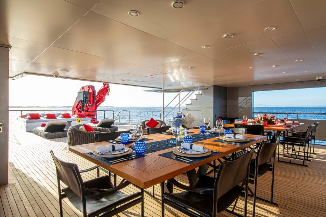 a table with chairs and a couch aboard AUDACE Yacht for Sale
