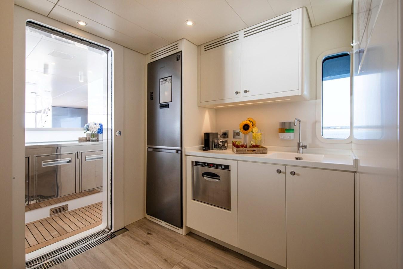 a kitchen with white cabinets aboard AUDACE Yacht for Sale