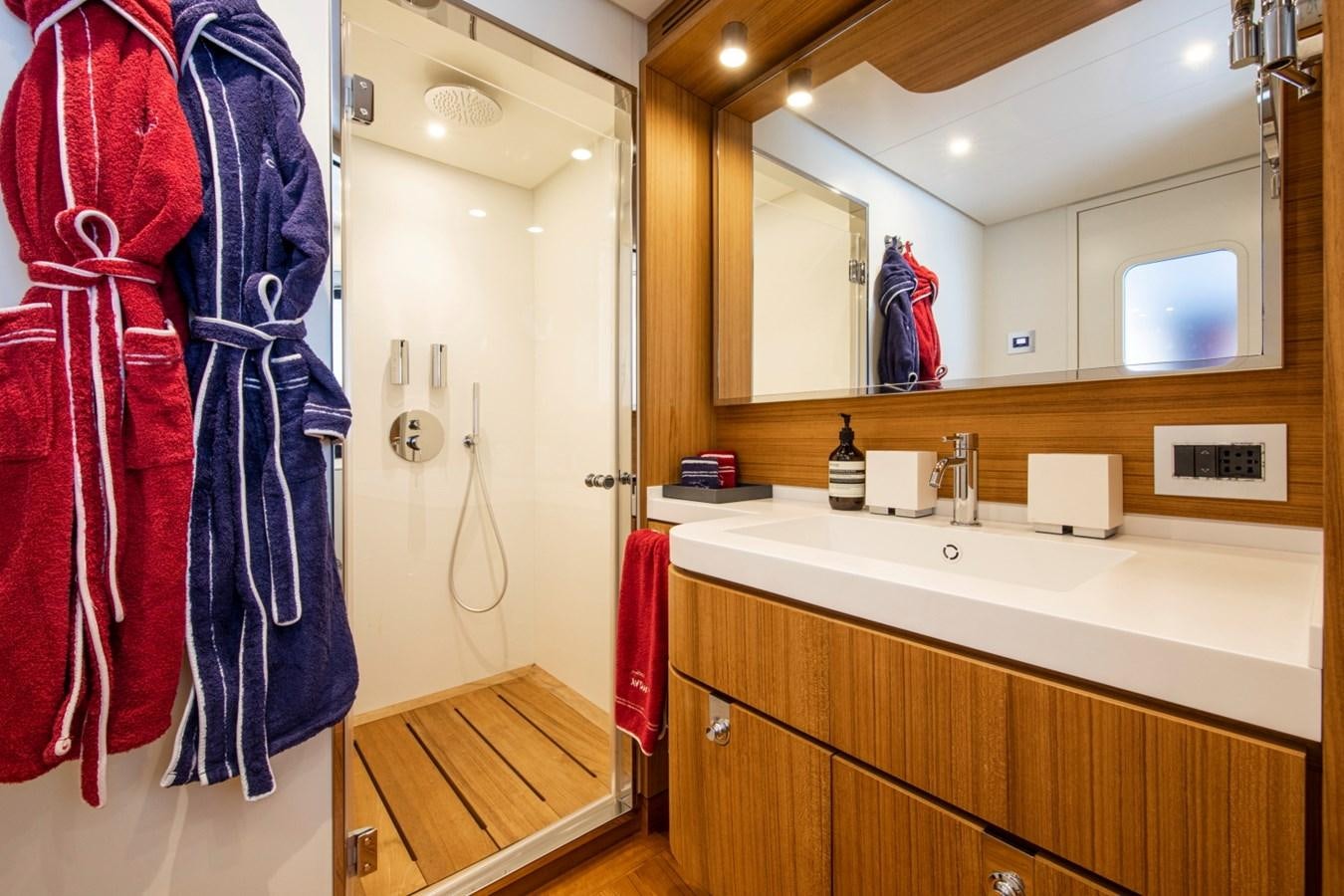 a bathroom with a robe on the wall aboard AUDACE Yacht for Sale