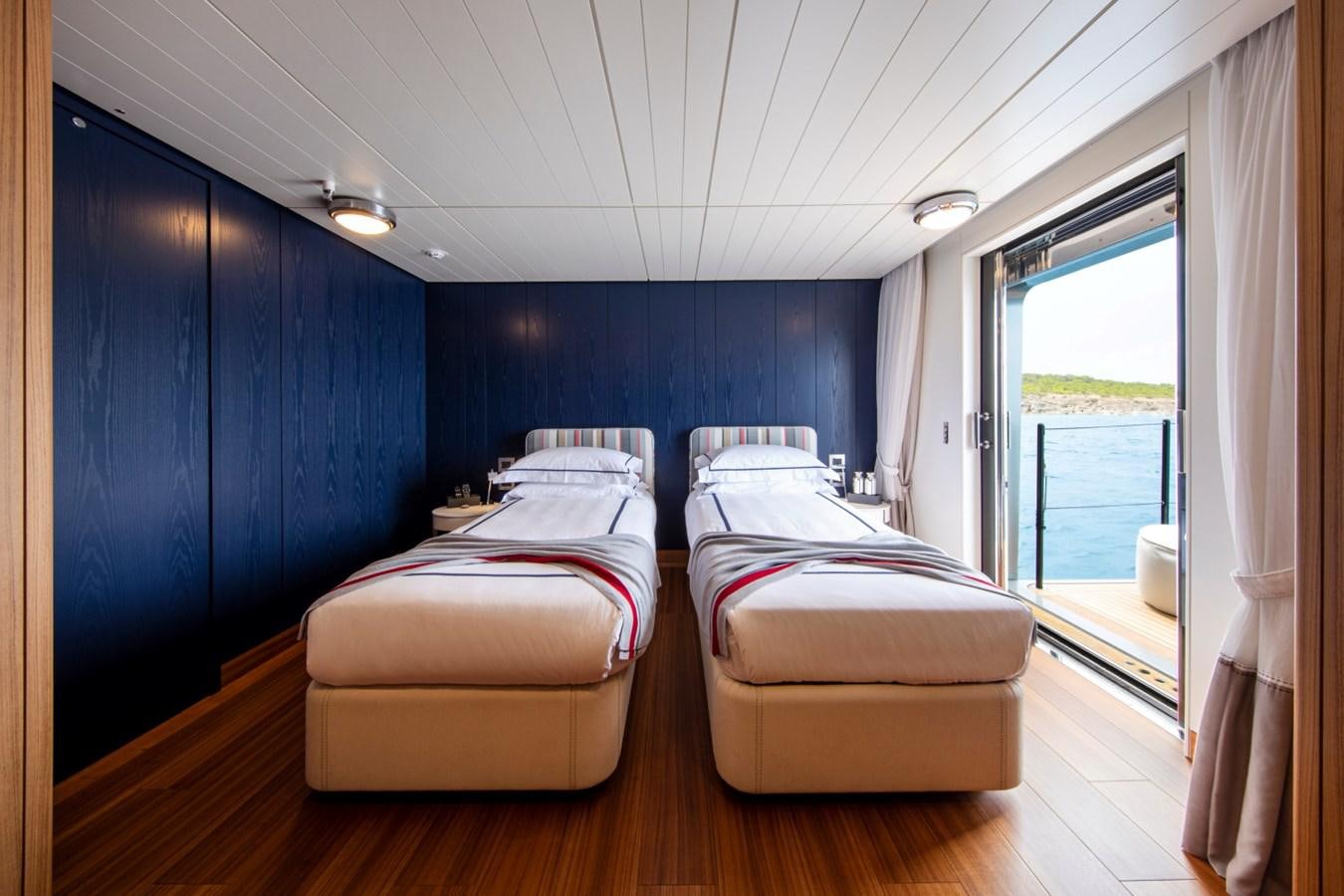 a room with a bed and a window aboard AUDACE Yacht for Sale