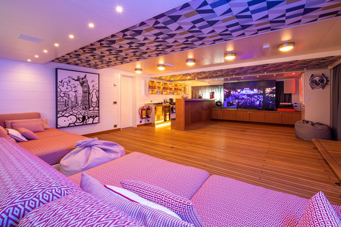 a large hotel room with a large bed and a large screen aboard AUDACE Yacht for Sale