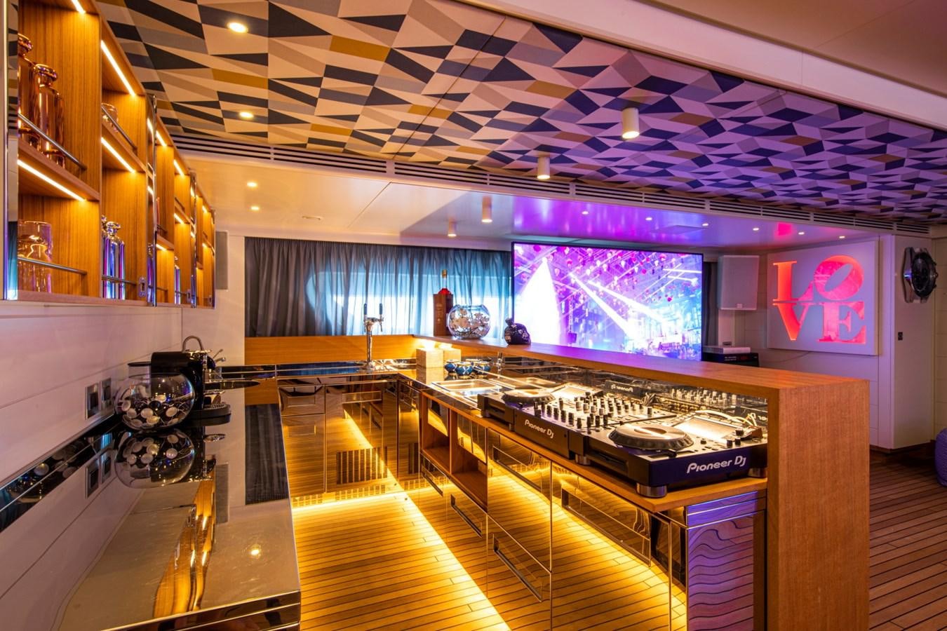 a room with a large stage and a large screen aboard AUDACE Yacht for Sale