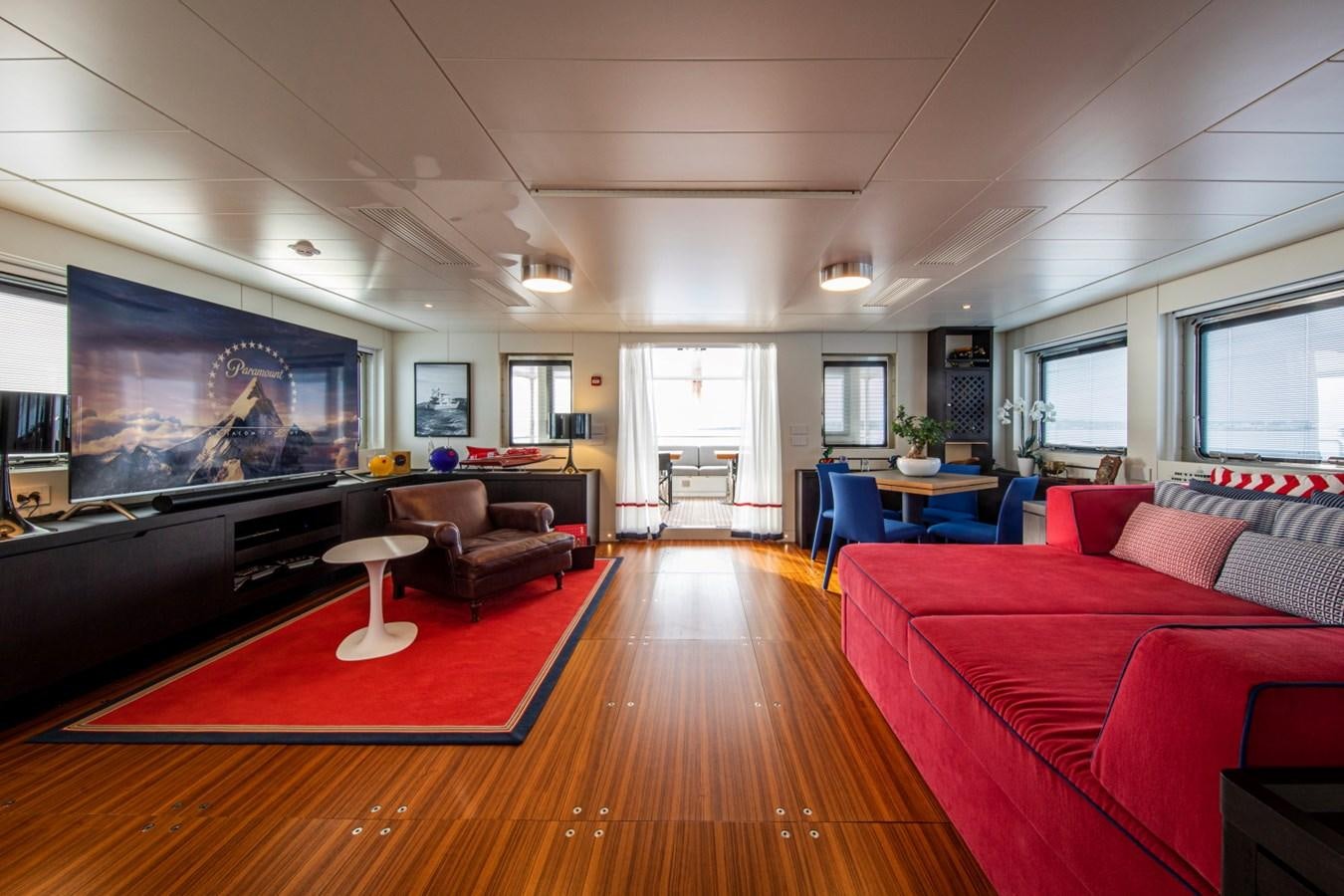 a living room with a large screen aboard AUDACE Yacht for Sale