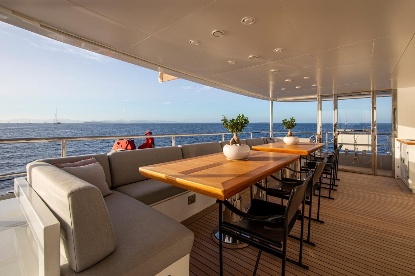 a room with a table and chairs aboard AUDACE Yacht for Sale