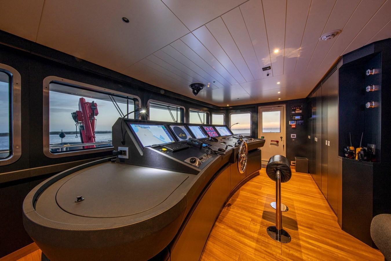 a room with a large table and a large window aboard AUDACE Yacht for Sale