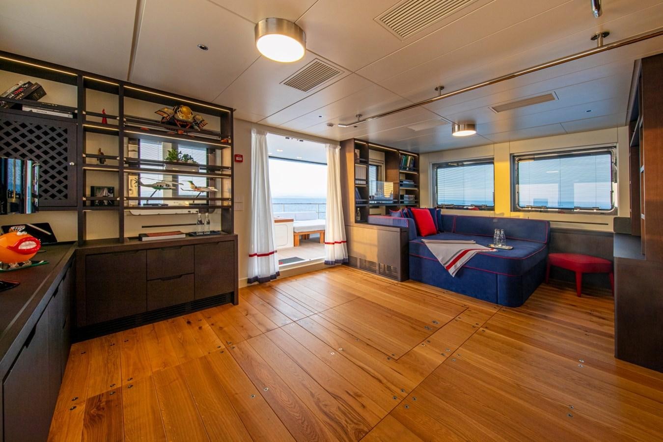 a large living room with a wood floor aboard AUDACE Yacht for Sale