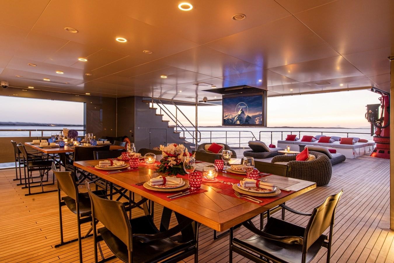 a room with tables and chairs aboard AUDACE Yacht for Sale